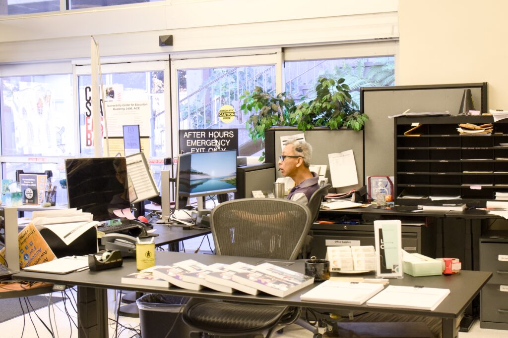 A student worker sits at the front desk of the ACE space.