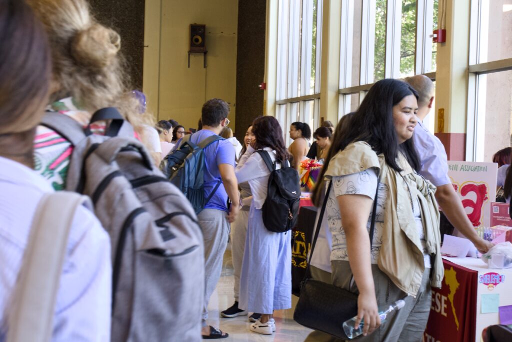 Students are gathered at various tables in Building 2300, checking out the Chabot clubs.