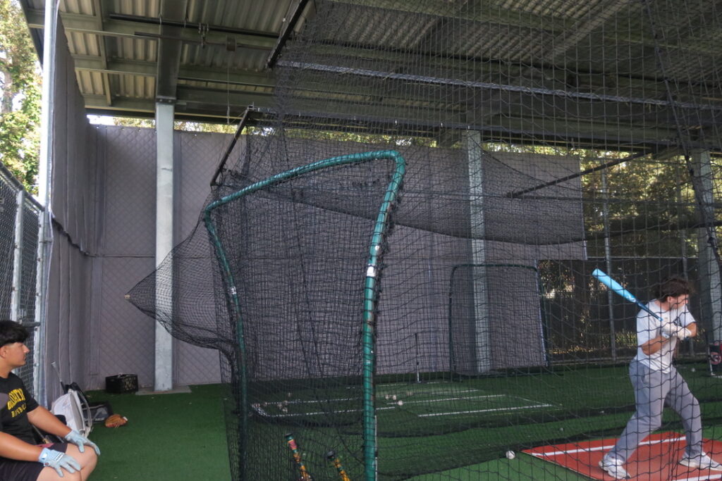 Chabot baseball player practicing batting in front of sound absorbing panels