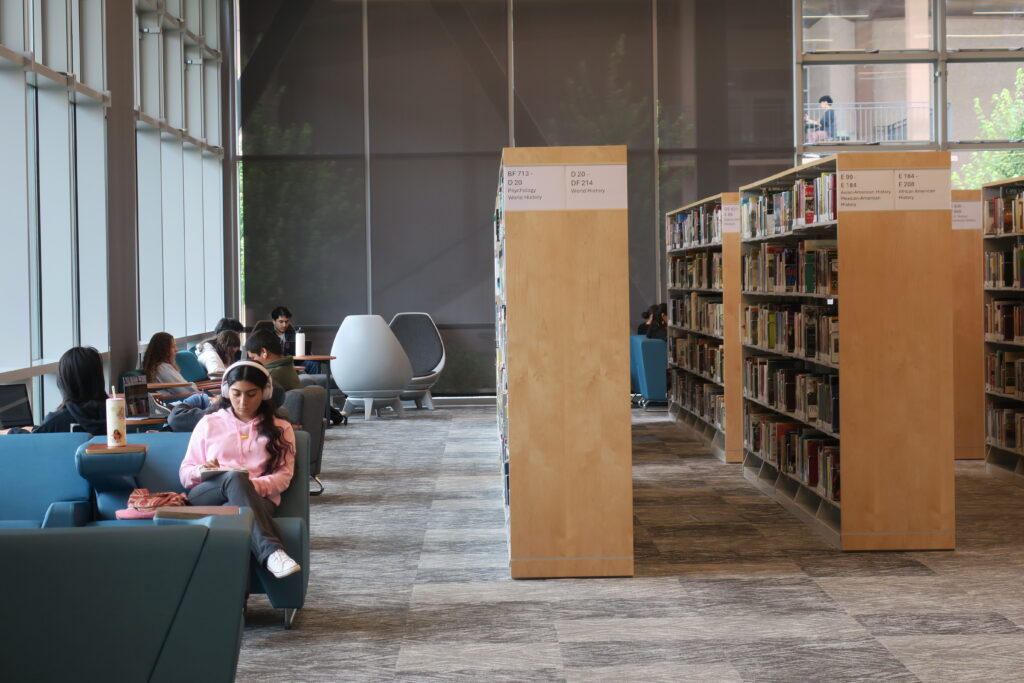 Student studying in corner of a library