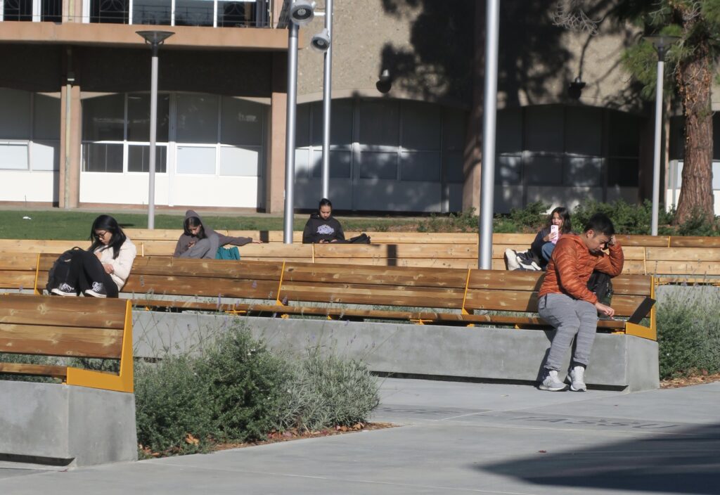 Students sitting on outdoor benches