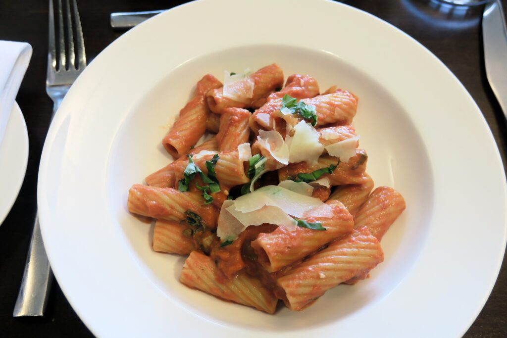 Pasta topped with marinara sauce, cheese and basil.